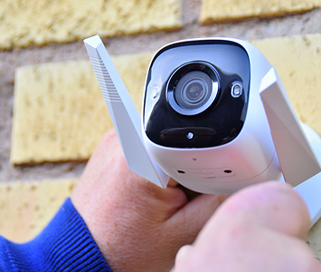Security expert fitting a wireless CCTV camera